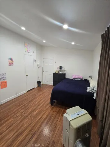 a bedroom with a bed and a mirror