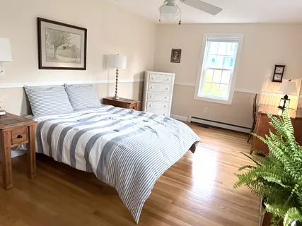 a bedroom with bed and wooden floor