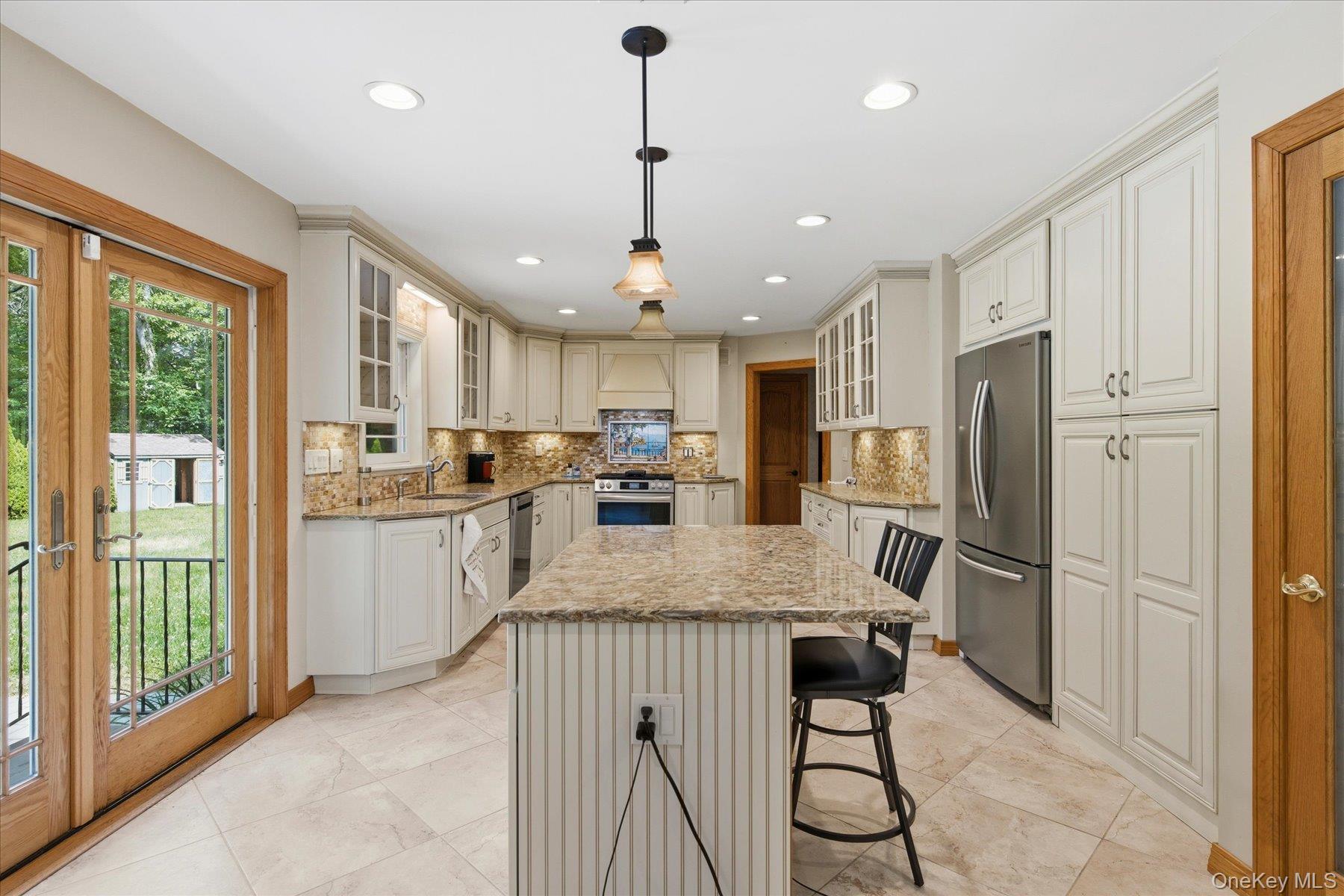 42 Cliff Road Port Jefferson, NY 11777 - Photo 10 of 22 a kitchen with a refrigerator a sink and cabinets