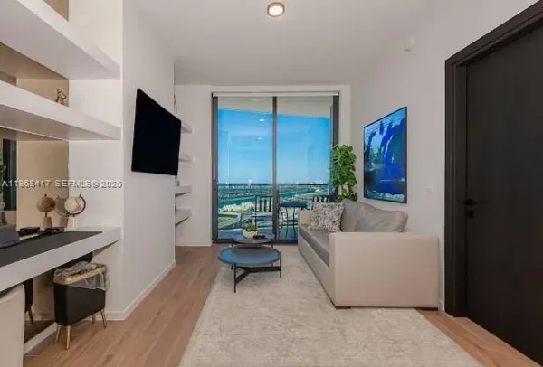 a living room with furniture and a flat screen tv
