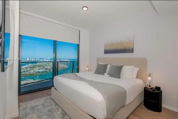 a bedroom with a bed and window