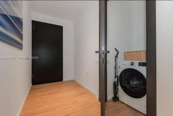 a view of a bedroom with washer and dryer