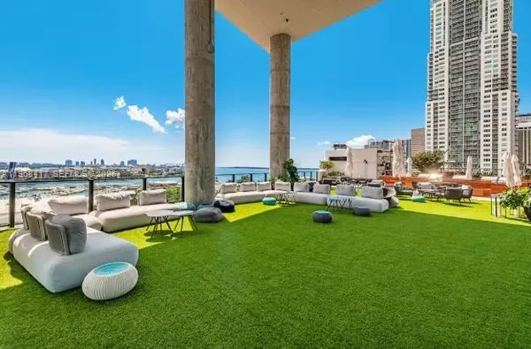 a swimming pool with outdoor seating and yard