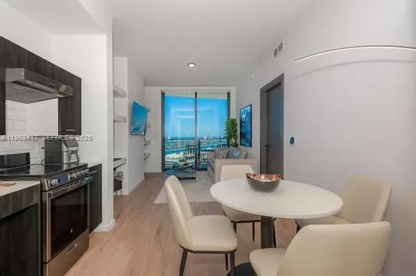 a kitchen with a table and chairs in it