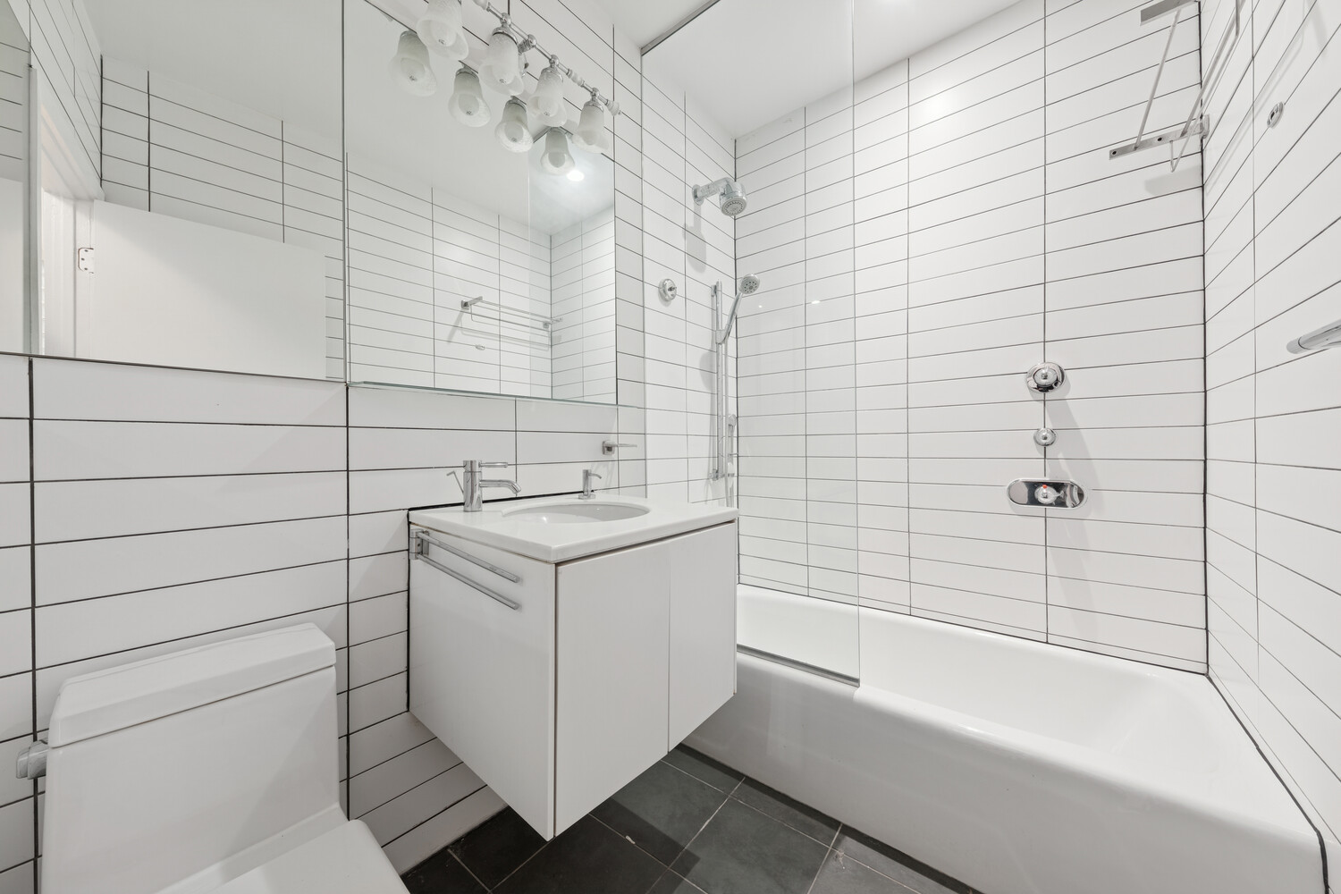 4 West 16th Street, Unit 7 Manhattan, NY 10011 - Photo 8 of 9 a bathroom with a sink and shower