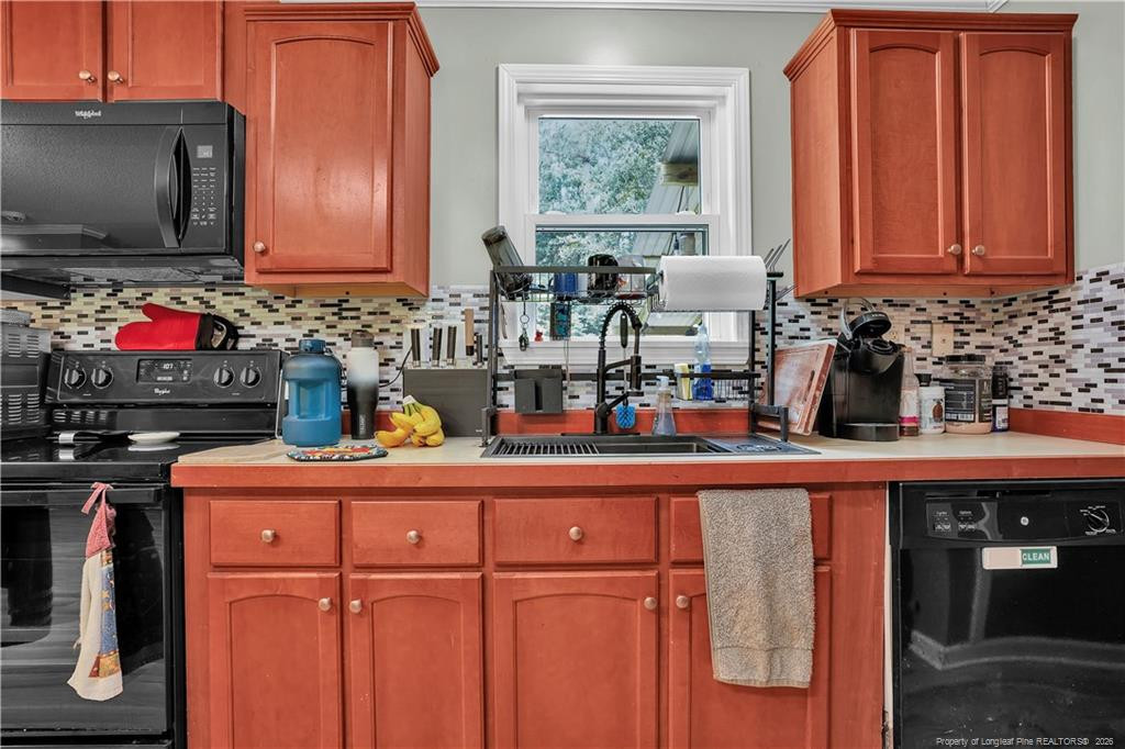 8155 Arabia Road Lumber Bridge, NC 28357 - Photo 12 of 30 a kitchen with stainless steel appliances granite countertop a refrigerator and cabinets