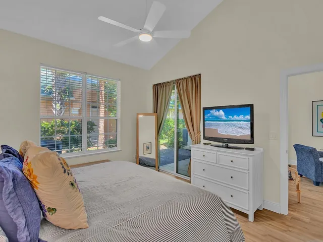 a bedroom with furniture and a flat screen tv