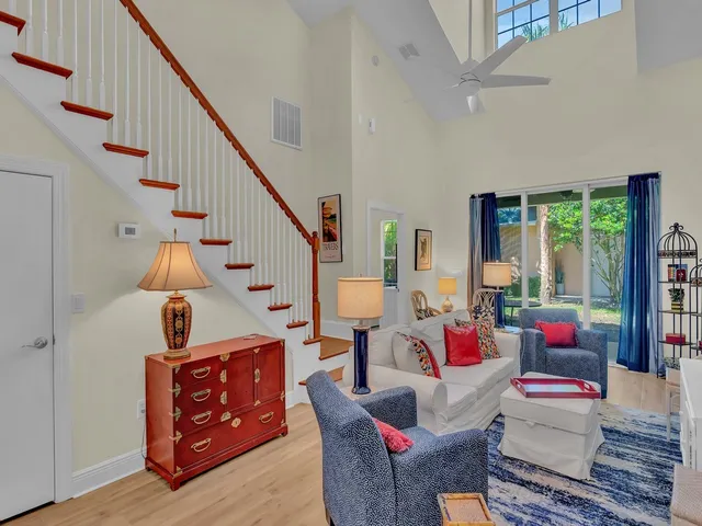 a living room with furniture and a dining table