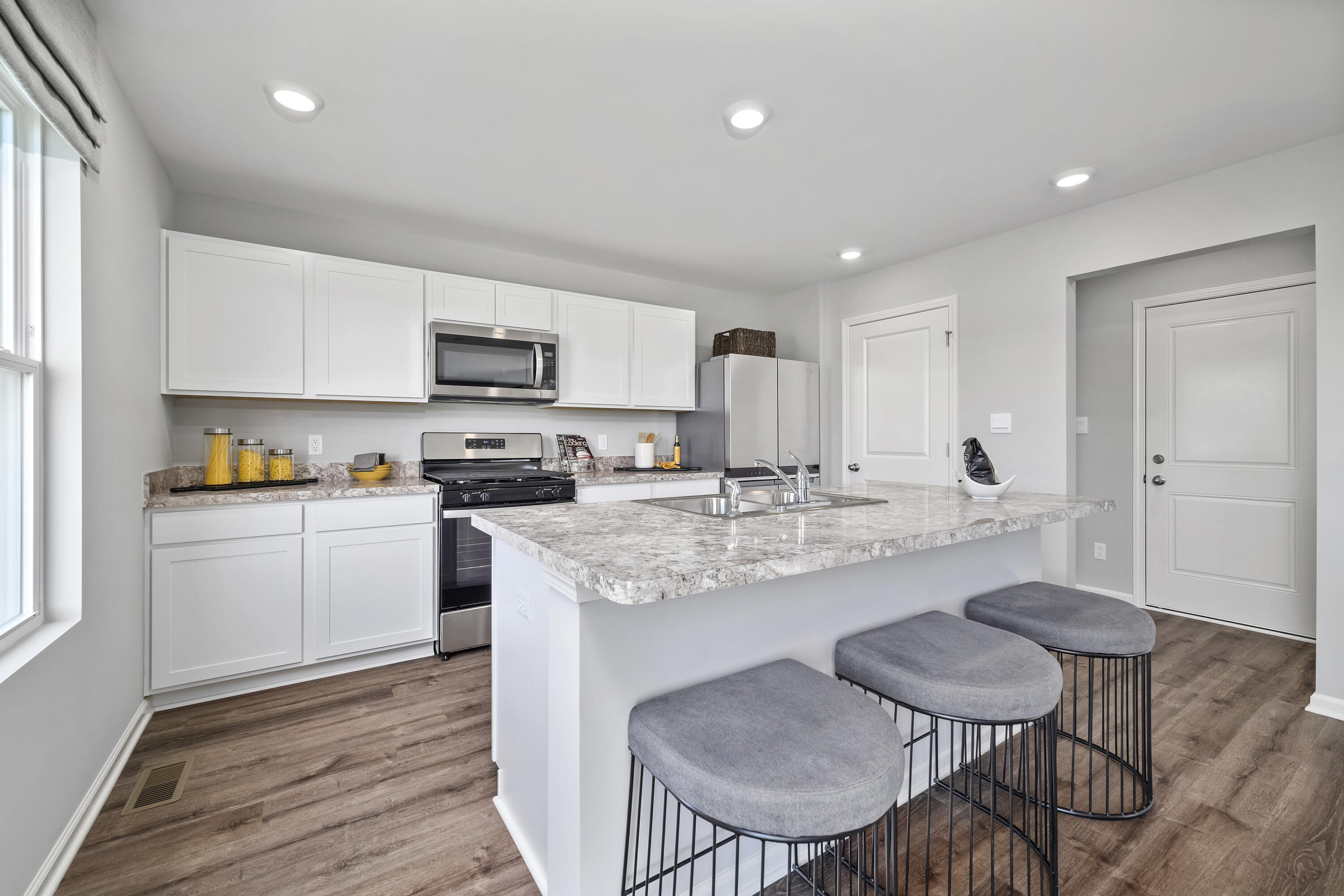 601 Petry Street Hebron, IN 46341 - Photo 5 of 44 a kitchen with a dining table chairs and refrigerator