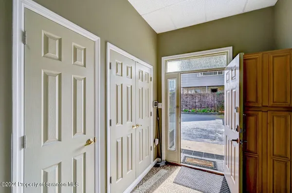 a living room with furniture a rug and a window