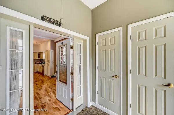 a living room with furniture a rug and a large window