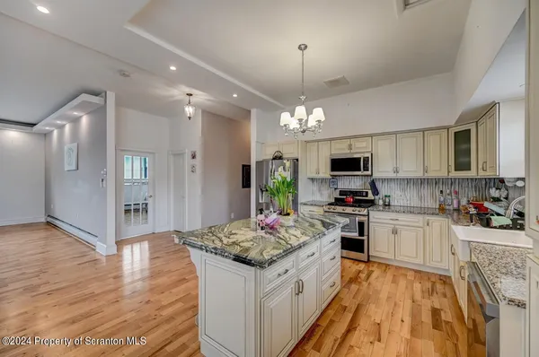a view of a dining room with furniture and a flat screen tv