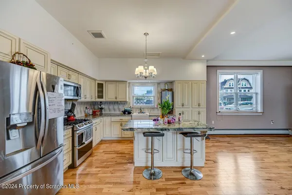 a bedroom with a bed and a tv on the dresser