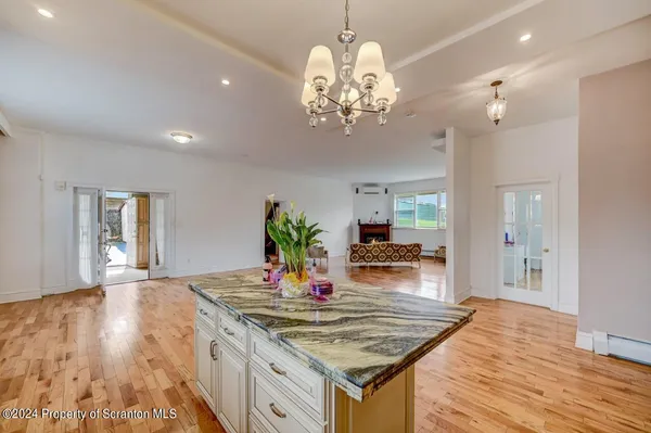 a bathroom with a sink mirror and a shower