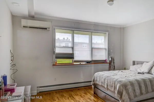 a bed room with a bed and a large window