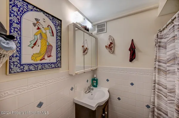 a bathroom with a sink vanity granite and toilet