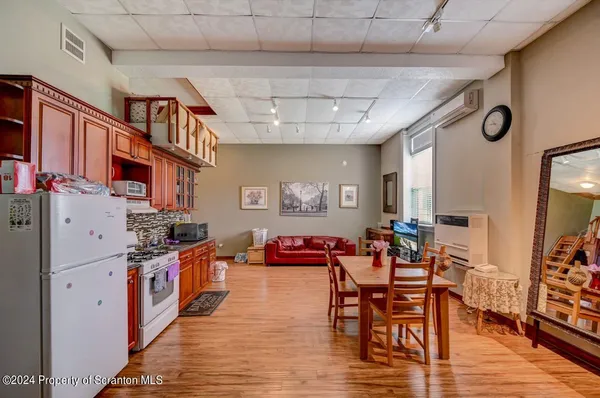 a kitchen with stainless steel appliances granite countertop a refrigerator and a cabinets