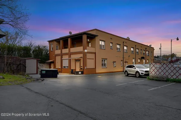 a kitchen with stainless steel appliances a stove refrigerator and cabinets