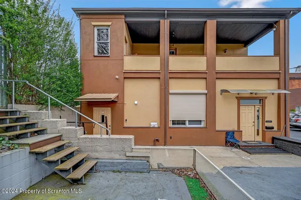 a large kitchen with kitchen island a large counter top space a sink stainless steel appliances and cabinets