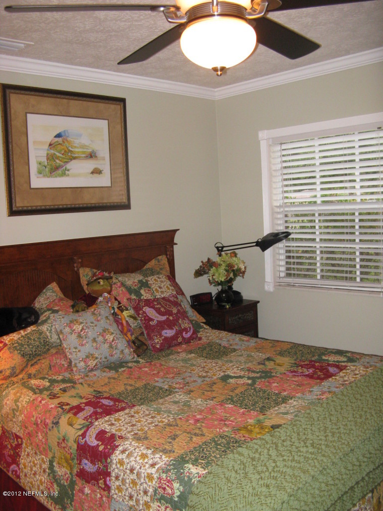 629 Segovia Road St. Augustine, FL 32086 - Photo 18 of 21 a bed sitting in a bedroom next to a window
