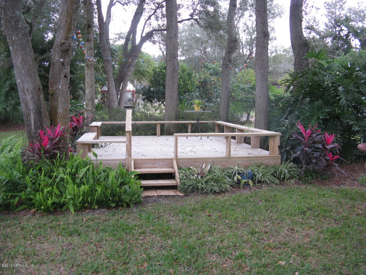 629 Segovia Road St. Augustine, FL 32086 - Photo 21 of 21 a view of a chair and table in the yard and large trees