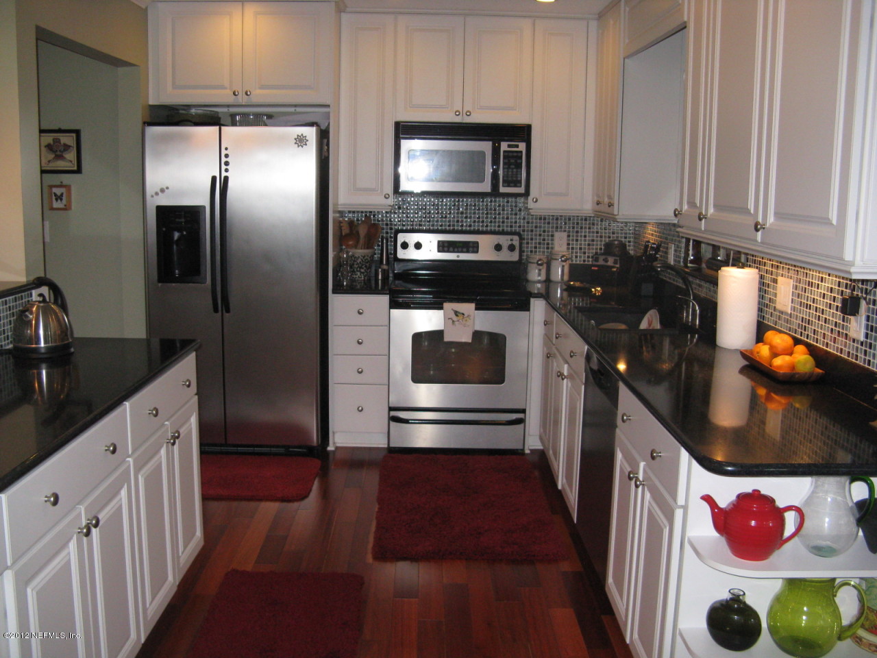 629 Segovia Road St. Augustine, FL 32086 - Photo 9 of 21 a kitchen with granite countertop stainless steel appliances and wooden cabinets