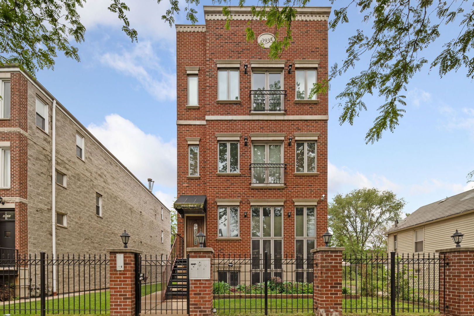 front view of a house with a iron gate
