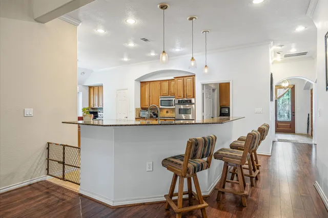 a view of a dining room with furniture and wooden floor
