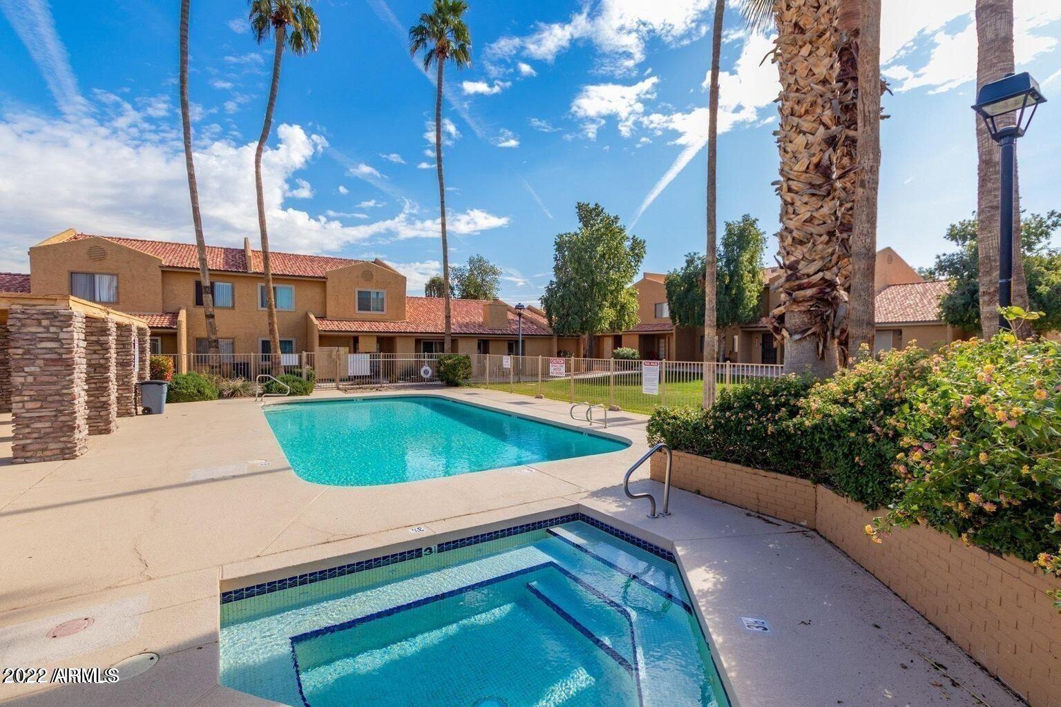 3511 East Baseline Road, Unit 1229 Phoenix, AZ 85042 - Photo 2 of 2 a view of a swimming pool with a chair and tables in the patio