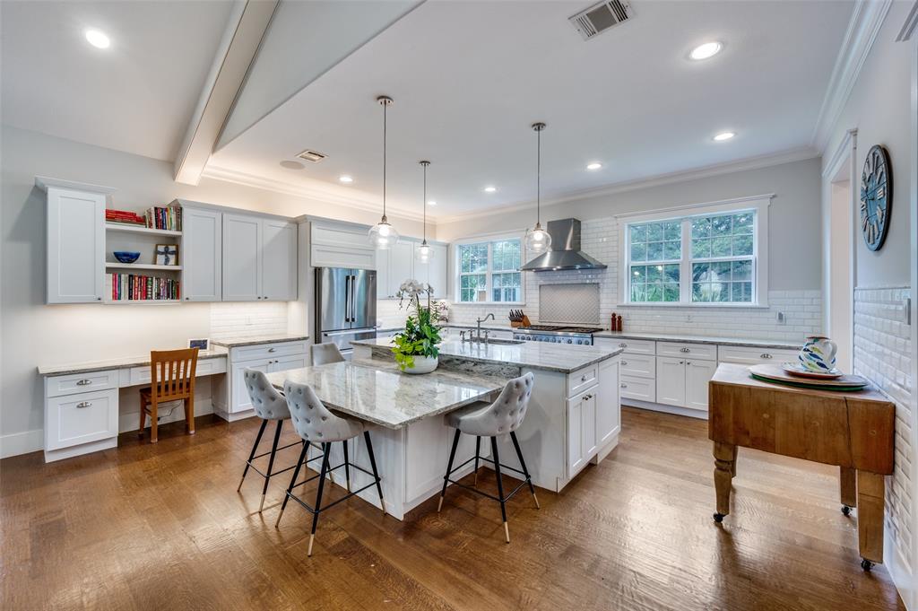 11240 Rosser Road Dallas, TX 75229 - Photo 4 of 18 a kitchen with a table chairs stove and wooden floor