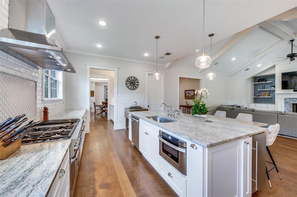 11240 Rosser Road Dallas, TX 75229 - Photo 5 of 18 a kitchen with a stove and a center island