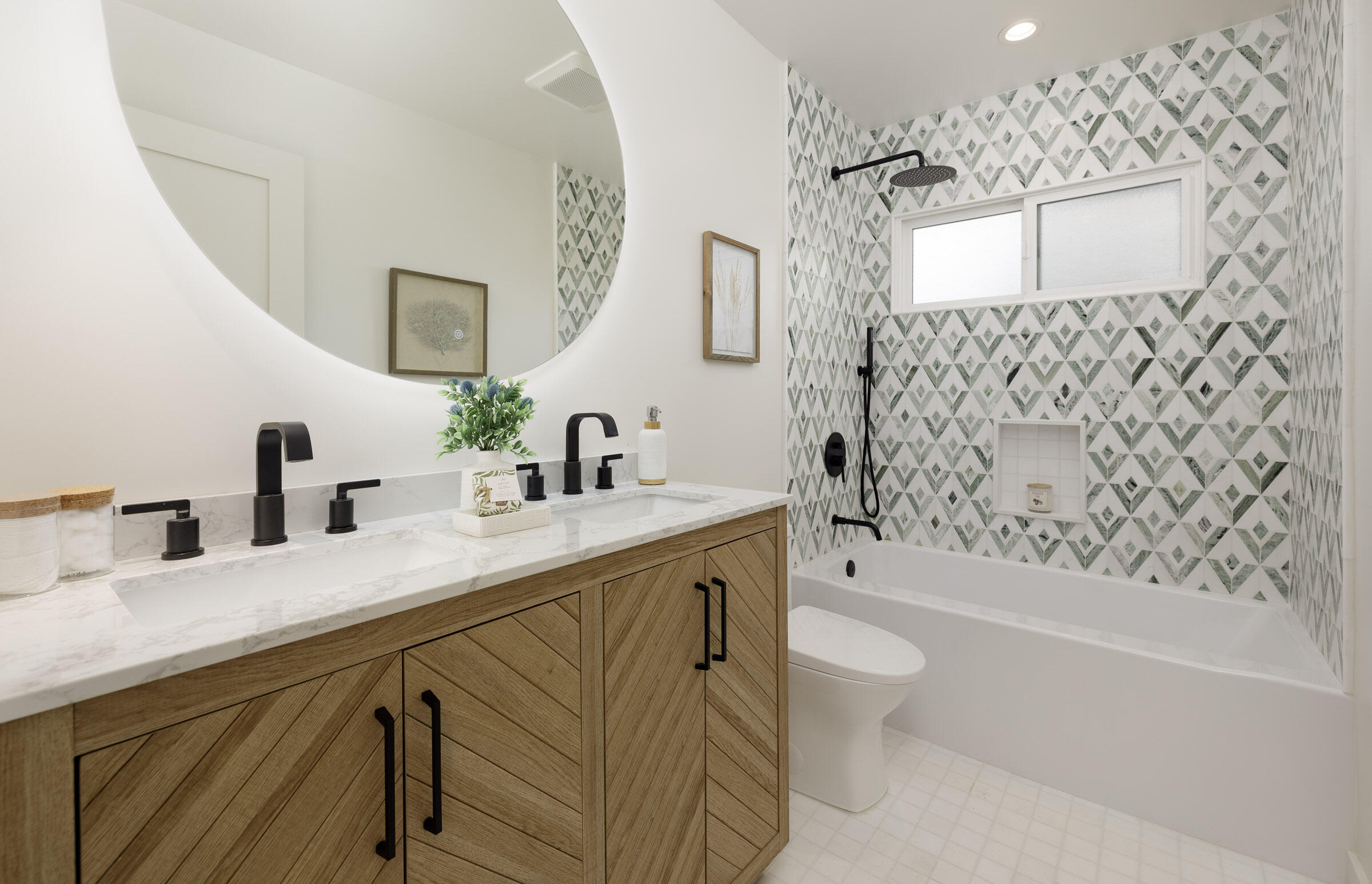 1377 Linhere Drive Carpinteria, CA 93013 - Photo 16 of 22 a bathroom with a granite countertop sink a toilet a mirror a vanity and shower