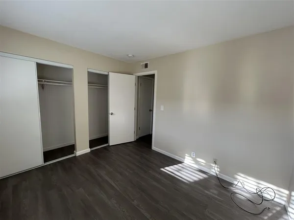 a view of wooden floor and windows in a room