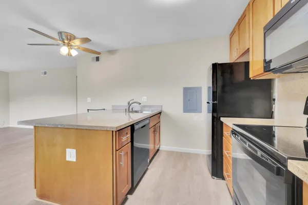 a kitchen with stainless steel appliances a stove a sink and a refrigerator