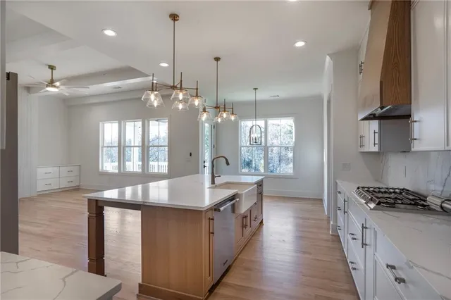 a kitchen that has a cabinets a stove and a refrigerator