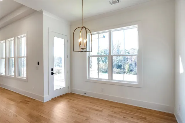 a view of an empty room with a window and fireplace