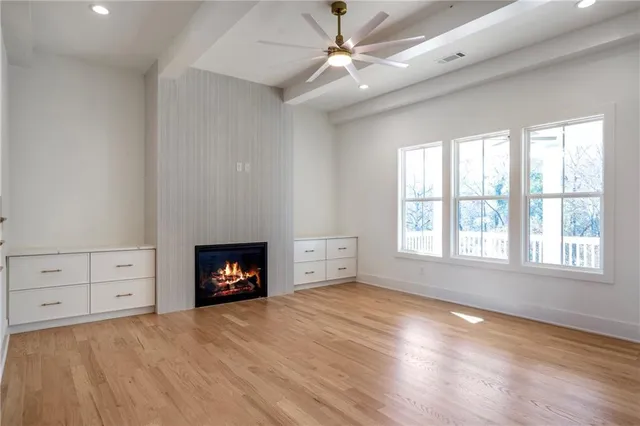 a view of a balcony with a floor to ceiling window with wooden floor