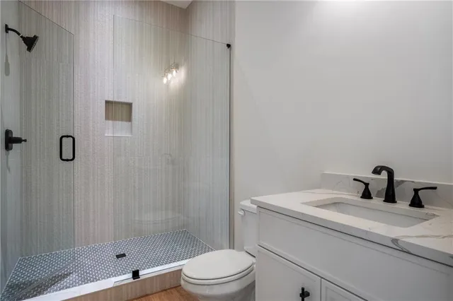 an empty room with windows and ceiling fan