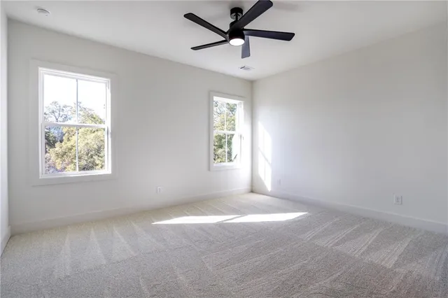 a kitchen with white cabinets and sink