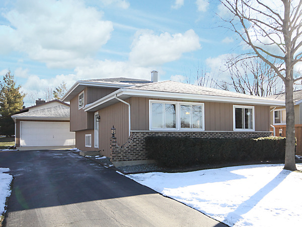 S031 Leonard Street Winfield, IL 60190 - Photo 1 of 25 a front view of a house with a garden