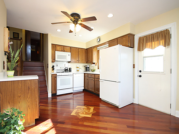 S031 Leonard Street Winfield, IL 60190 - Photo 12 of 25 a kitchen with a refrigerator a sink and cabinets