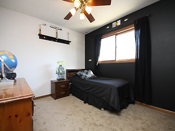 S031 Leonard Street Winfield, IL 60190 - Photo 16 of 25 a bedroom with a bed and a chandelier