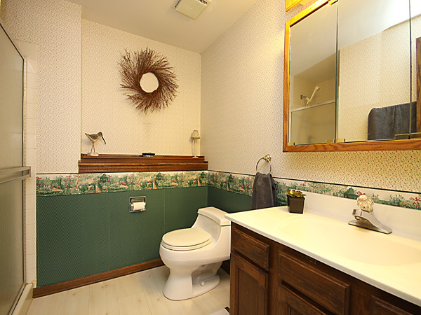 S031 Leonard Street Winfield, IL 60190 - Photo 21 of 25 a bathroom with a toilet sink and mirror