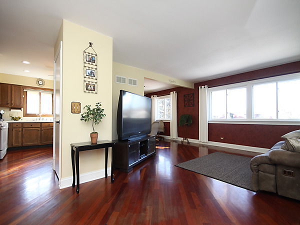 S031 Leonard Street Winfield, IL 60190 - Photo 5 of 25 a living room with furniture and a flat screen tv with wooden floor