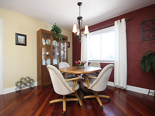 S031 Leonard Street Winfield, IL 60190 - Photo 8 of 25 a dining room with furniture a chandelier and wooden floor