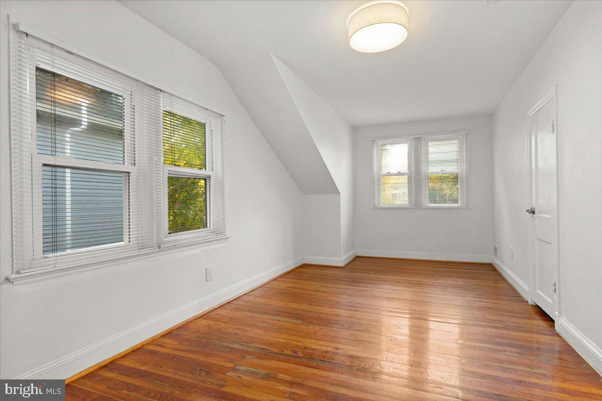 4302 30th Street Mount Rainier, MD 20712 - Photo 15 of 23 a view of an empty room with wooden floor and a window