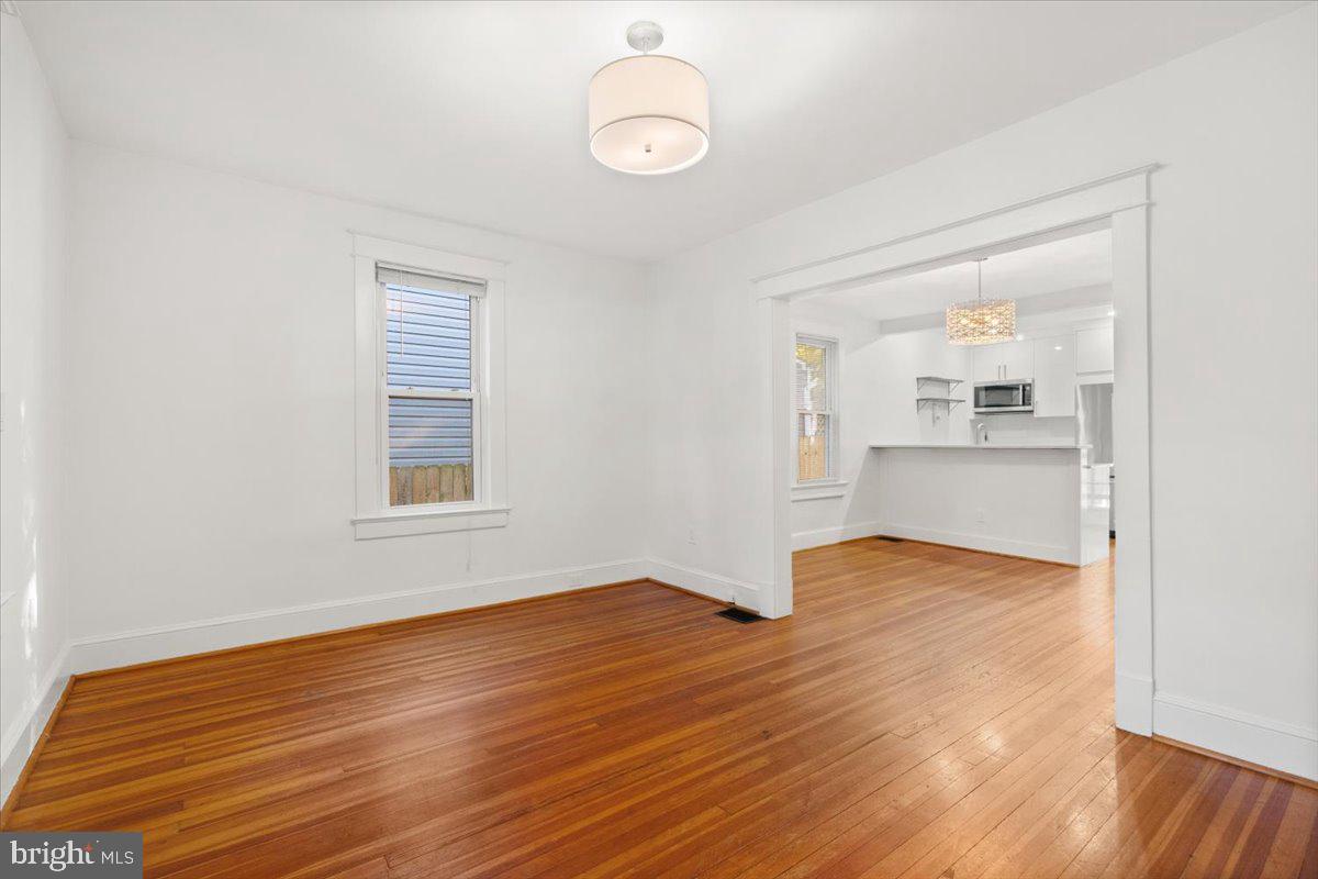 4302 30th Street Mount Rainier, MD 20712 - Photo 2 of 23 an empty room with wooden floor and windows