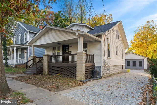 a view of a house with a patio and a yard