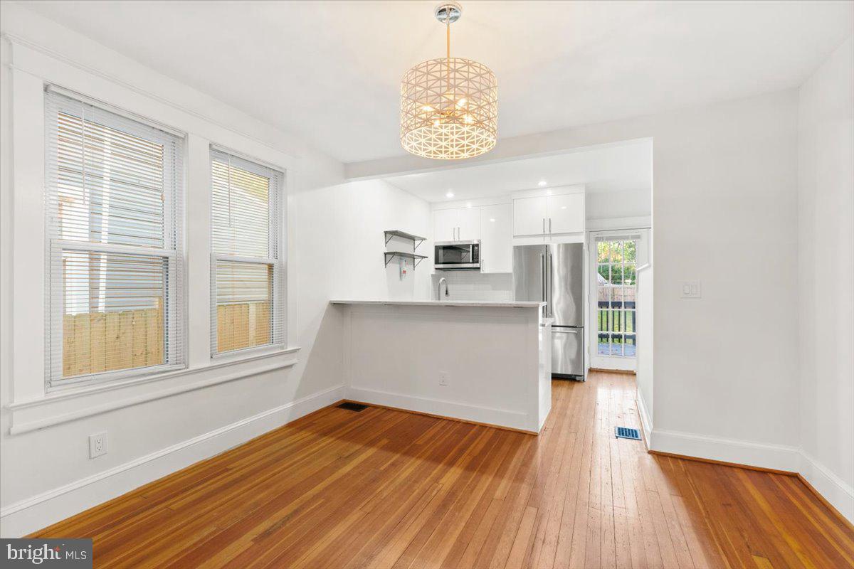 4302 30th Street Mount Rainier, MD 20712 - Photo 3 of 23 a view of an empty room with wooden floor and a window
