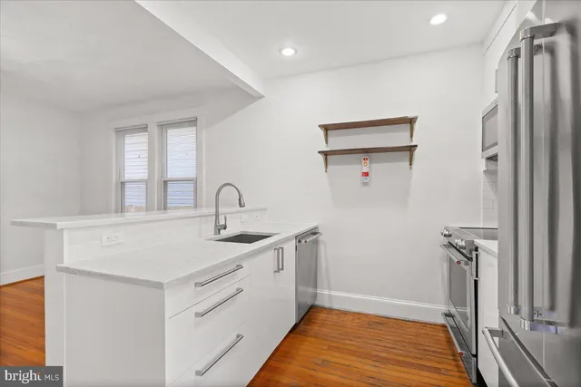 a kitchen with a sink and a refrigerator